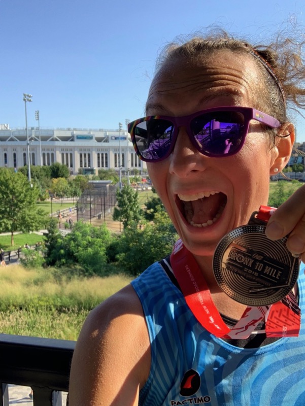 Amelia with her medal in front of Yankee Stadium